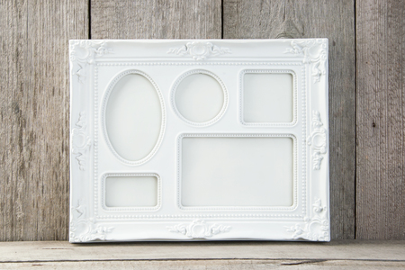 Empty white picture frame on old wooden gray textured background. Home decor and copy space for text.の写真素材