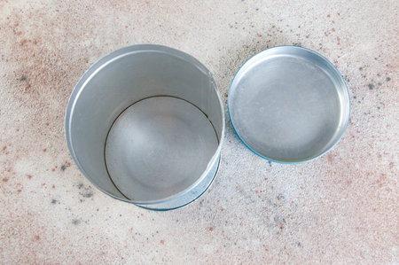 Open old vintage blue tin canister on concrete background. Copy space for text.