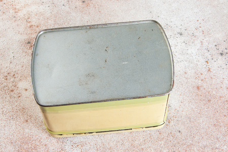 Old vintage yellow tin box on concrete background. Copy space for text.の写真素材