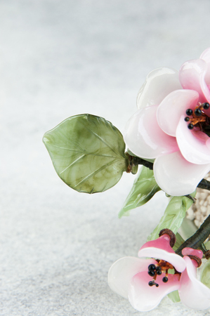 Pink glass flowers on concrete background. Copy space for text.の写真素材