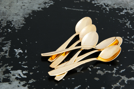 Vintage golden coffee spoons on black background. Copy space for text.の写真素材