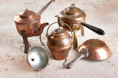 Vintage copper kitchen utensils on a concrete background. Props for food photography and copy space for text.の写真素材