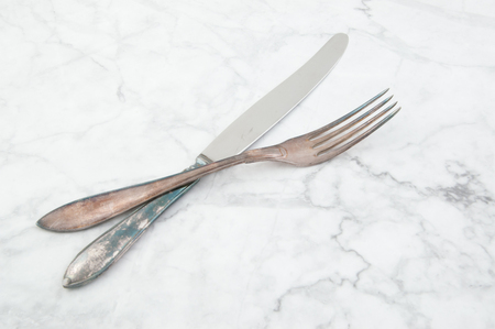 Vintage knife and fork on white gray background. Copy space for text.の写真素材