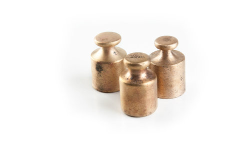 Antique bronze weights for scales on white background. Kitchen decor, food photography props.
