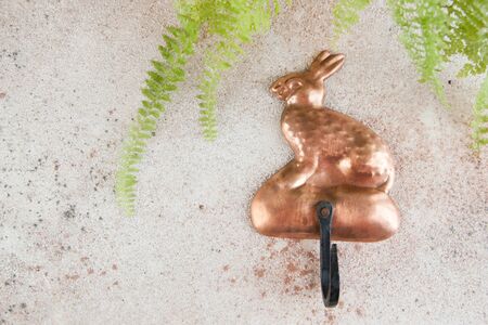 Ancient copper hanger hook for clothes and towels on concrete background. Copy space for text.の写真素材