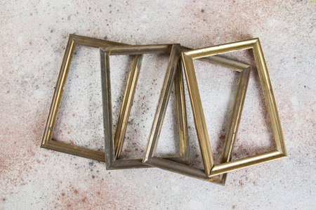 Four old empty picture frames on concrete background. Photography props and copy space for text.
