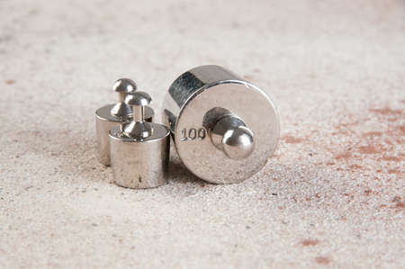 Antique weights for scales on concrete background. Copy space for text and food photography props.の写真素材