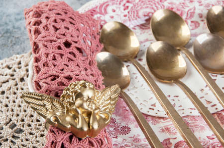 Old bronze cocktail spoons on vintage dish. Copy space for text, food photography props.の写真素材