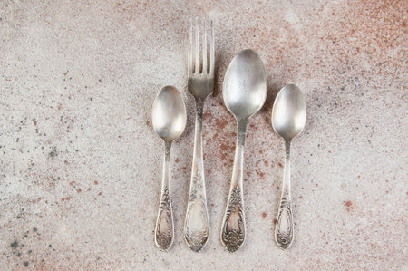 Antique metal cutlery on concrete background. Copy space for text and food photography propsの写真素材