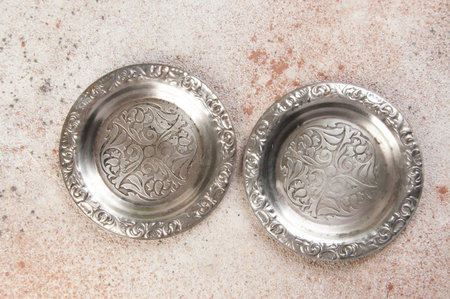 Old metal coasters, small dish on concrete background. Copy space for text.の写真素材