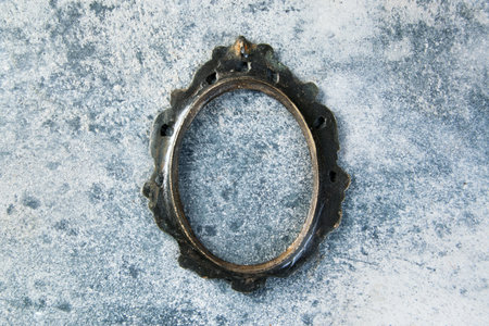 Antique brass empty picture frame on concrete background. Photography props and copy space for text.の写真素材