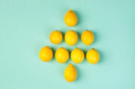 Fresh yellow lemons on yellow menthol background.の写真素材