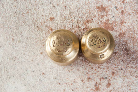 Antique bronze weights for scales on concrete background. Copy space for text and food photography props.の写真素材