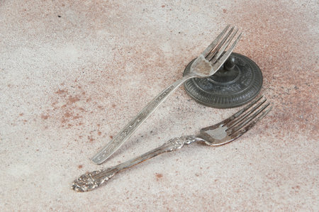 Two old metal forks. Copy space for text, food photography props.の写真素材