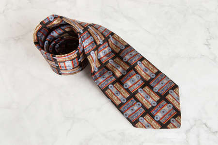 Blue neck tie with geometric pattern on marble background. Copy space for text.の写真素材