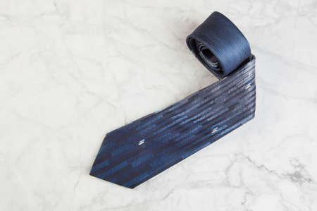Blue neck tie on marble background. Copy space for text.の写真素材