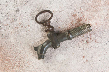 Old bronze wine barrel crane on concrete background. Copy space for text.の写真素材
