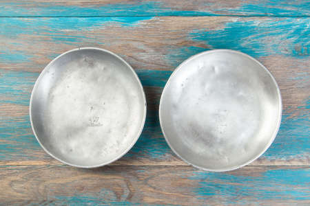 Old aluminum plates for scales on wooden blue background. Copy space for text.の写真素材