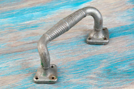 Antique aluminum door handle on wooden background. Copy space for text.の写真素材