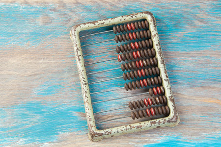 Vintage metal abacus on wooden background. Copy space for textの写真素材