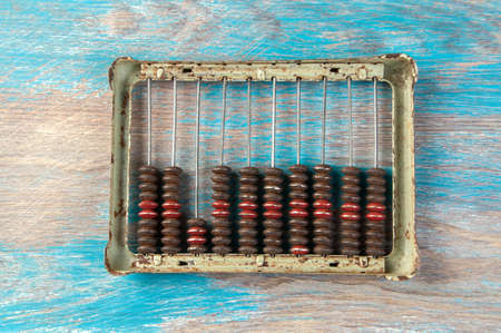 Vintage metal abacus on wooden background. Copy space for textの写真素材