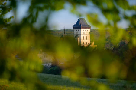State castle Karlstejn, as viewed through the green leavesのeditorial素材