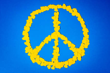 Yellow hearts forming the peace sign. Papercut concept with ukraininan colors - yellow and blueの写真素材