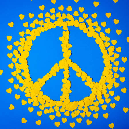 Yellow hearts forming the peace sign. Papercut concept with ukraininan colors - yellow and blueの写真素材