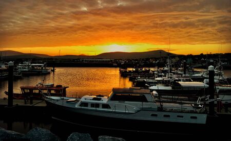 Beautiful Orange sunset above Dingle Marina in Ireland.の写真素材