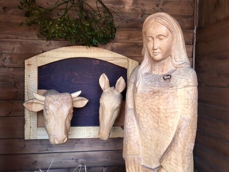 Christmas crib carved out of wood. Sculptures on the nativity scene: Virgin Mary, donkey and bull. Czech traditional carvingの写真素材