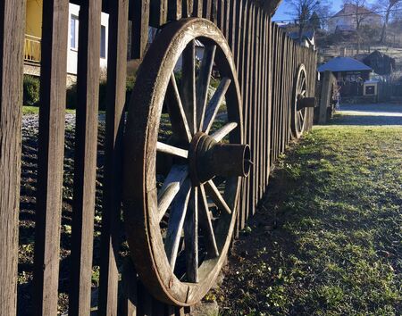 Traditional wooden fence with wheel embedded insideの写真素材