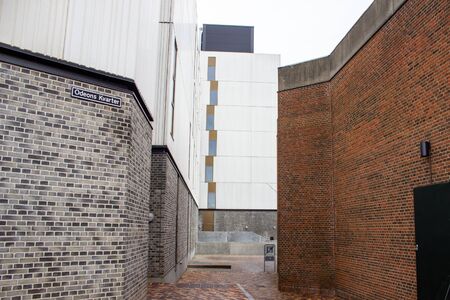 Clean, bright and beautiful brick alley between modern buildings in Odense. Denmark.の写真素材