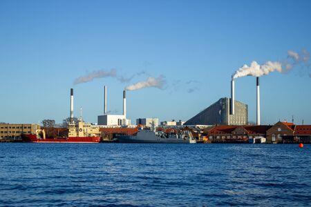 Large ships moored at the incinerator. Beautiful sunny weather in winter in Copenhagen city.の写真素材