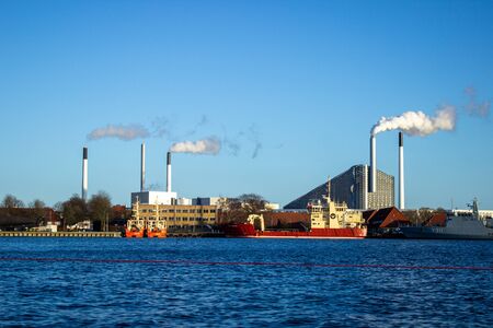 Large ships moored at the incinerator. Beautiful sunny weather in winter in Copenhagen city.の写真素材