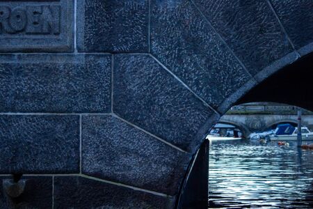 Detail of a stone arch bridge on a water canal in Copenhagen city. Denmark.の写真素材