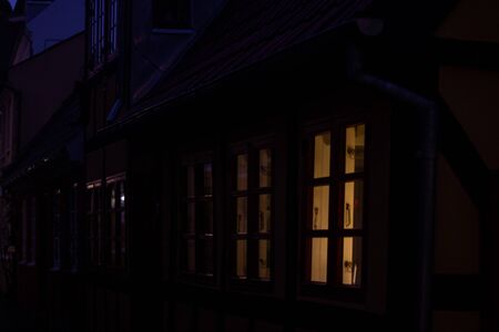 Beautiful windows in night and shutters on the facade of a historic house in Denmark.の写真素材