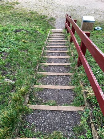 Red autumn forest park stairs view. Mist forest stairway in red autumn. Red autumn stair down view. Red autumn forest mist stairway view.の写真素材