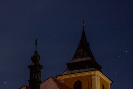 Detail of night illuminated historic Catholic church in moonlight.の写真素材