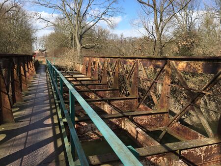 Railroad bridge over a gravel road in rural Czech Republic.の写真素材