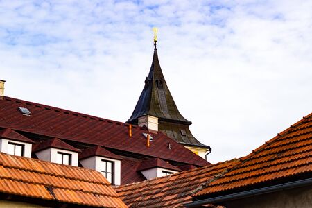 Beautiful medieval Czech church tower behind leafless trees. Czech Republic.の写真素材