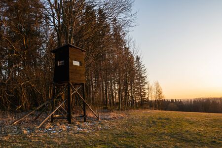 Hunting tower in wild forest. Wooden Hunter Hide High watch post tower. Hunter's observation point in forest in Europe. Czech Republic.の写真素材