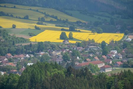 A beautiful Czech Republic agriculture landscape with light and yellow rape fields.の写真素材