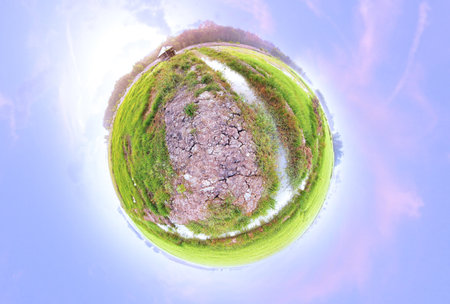 Mini planet of a little barn on the field 