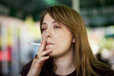 Young woman smoking a cigaretteの写真素材