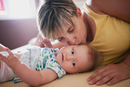 Mother and daughter laying on the bed
