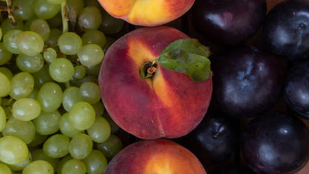 Grapes, peach and plum - fruit background close-upの写真素材