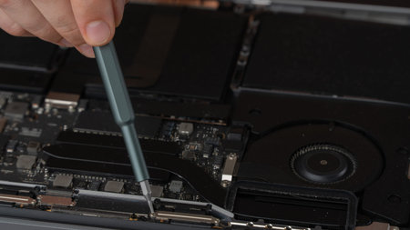 Repair and maintenance of computer laptop screwdriver unscrews the internal screw of the system