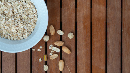 Oatmeal in a cup and nuts breakfast space for textの写真素材