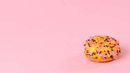 Cake with multi-colored confectionery dressing on a pink backgroundの写真素材