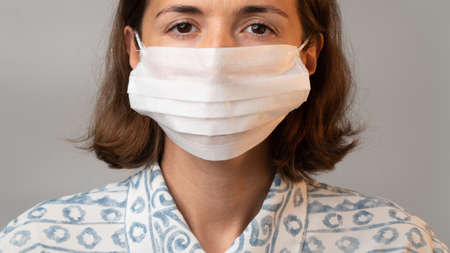 Face of a woman in a white mask on her face close-up. high quality photoの写真素材